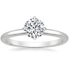 a white gold engagement ring with a round diamond in the center, on a plain band