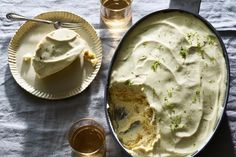 a pan filled with mashed potatoes next to two glasses