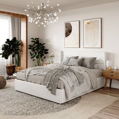 a bedroom with a large bed and potted plants