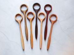 four pairs of scissors sitting on top of a white countertop next to each other