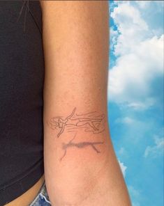 a woman's arm with a tattoo on the left side of her right arm