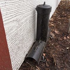 a black pipe sticking out of the side of a building