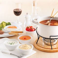 a table topped with bowls and plates filled with soup