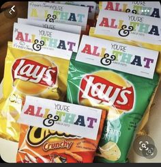 four bags of lays and chips sitting on top of each other in front of a box