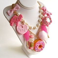 This kawaii statement necklace features tons of fun pink charms inspired by all things cute nostalgic and magical, making this necklace a true statement piece! I designed these charms to be so realistic you might be tempted to take a taste! This statement necklace features your choice of 5, 7 or 9 charms (pictured) that hang from a high quality gold or silver plated 20" chain necklace accented with a hand-beaded glass pearl chain and pink bow. Back closes with a lobster clasp and is finished wit Pink Fun Style Charm Necklace, Fun Pink Charm Necklaces, Playful Pink Charm Necklaces, Handmade Pink Harajuku Style Necklace, Sweet Pink Charm Jewelry, Sweet Pink Necklaces For Party, Sweet Pink Jewelry With Charms, Sweet Pink Necklace For Party, Pink Kawaii Charm Necklaces For Birthdays