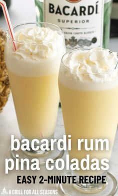 two glasses filled with whipped cream next to a bottle of bacardi rum pina coladas