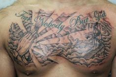 a man's chest with tattoos and words on it