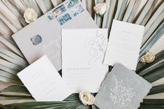 the wedding stationery is laid out on top of each other