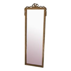 a tall wooden mirror sitting on top of a white wall next to a floor lamp