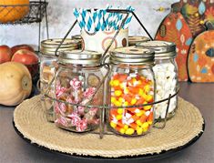 three jars filled with candy sitting on top of a table