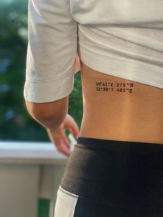 the back of a woman's stomach with numbers on it