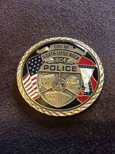 a police badge is shown on a brown carpeted surface with the words north little rock