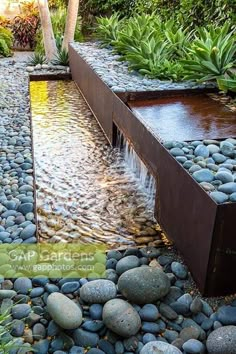 a garden with rocks and water flowing from it