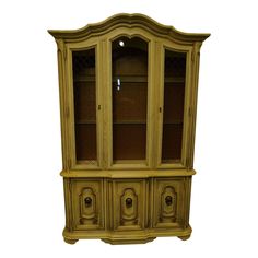 an old fashioned china cabinet with glass doors and knobs on the front, against a white background