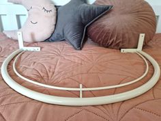 a bed with two pillows on top of it and a white headboard frame in the middle