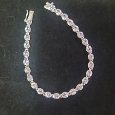 B105 $129 7 1/4". Oval Blue Tanzanite Rhodium Over Sterling Silver Tennis Bracelet 4.05ctw. 9.2 Grams. Measures Approximately 0.40"W. Box Clasp. Est Retail Value: $488.00 Silver Tennis Bracelet, Blue Tanzanite, Box Clasp, Tennis Bracelet, Womens Jewelry Bracelets, Tennis, Size 7, Women Jewelry, Bracelet