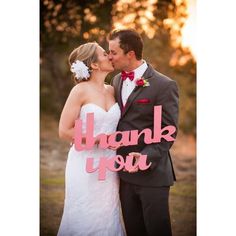 a bride and groom kissing in front of the words thank you