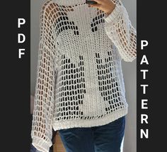 a woman wearing a white crochet sweater using her cell phone