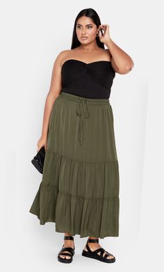 Romance comes alive in the Summer Tier Skirt. Revealing an elastic waistline to cinch your waist in, the tiered design adds a bohemian feel to your outfit. Key Features Include: - Elasticated drawstring waistline - Tiered design - Flared silhouette - Pull up style - Fully lined - Midi length Team up with a form fitted top to achieve a balanced look. | Plus Size Summer Tier Skirt in Khaki, Size 14 | City Chic Casual Green Tiered Bottoms, Green Tiered Beach Skirt, Bohemian Tiered Bottoms With Elastic Waistband, Tiered Green Beach Skirt, Green Tiered Maxi Skirt For Summer, Drawstring Tiered Maxi Skirt For Vacation, Vacation Tiered Maxi Skirt With Drawstring, Bohemian Style Tiered Gathered Skirt, Bohemian Tiered Gathered Skirt