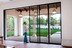 a man standing in front of a sliding glass door