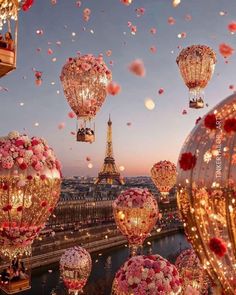 the eiffel tower in paris is lit up with pink and white flowers as balloons float above