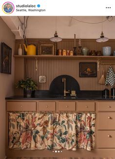 an old fashioned kitchen with lots of counter space and decor on the shelves above it