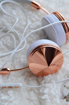 two headphones laying on top of a white rug