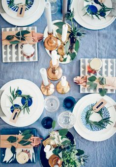 the table is set with plates, napkins and place settings for dinner guests to enjoy