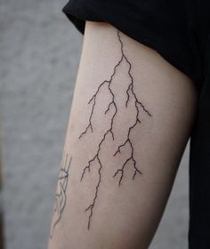 a woman's arm with lightning tattoo on it