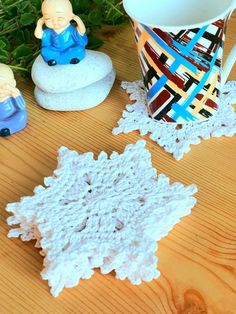 crocheted doily next to small ceramic figurines on wooden table top