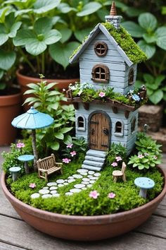 a potted planter with a miniature house in it's center filled with plants