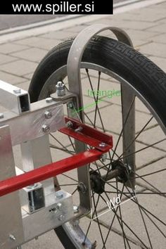 the front wheel of a bicycle with red bars