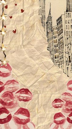 a piece of paper with red lipstick on it and buildings in the background that have hearts drawn on them