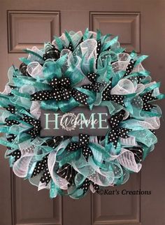 a wreath with the word home on it and black, white and green mesh ribbons