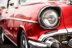 the front end of an old red car with chrome grilles and headlights - stock photo - images