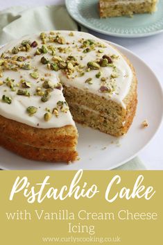 a cake with white frosting and pistachioo toppings on top is sitting on a plate