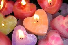 many heart shaped candles are lit in the shape of hearts with different colors and shapes