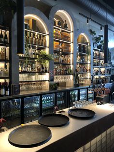 an empty bar with plates on the counter