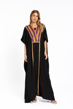 A colorful embroidered caftan will make you feel like African royalty. It's extremely elegant with a dash of classy cotton embroidery in the front. Ideal for plus size women as well. Made of extremely soft fabric to make you feel free and beautiful at the same time.  This Kaftan is ideal to wear for any casual occasion. Whether taking a trip down the shopping lane, or home-based kitty parties, or about anything else, wearing this dress will make you feel classy and comfortable. Fabric : 70% Egyptian cotton and 30% polyester Size : Free sized dress. Fits up to a 5XL US.  Kaftan Measurements : Bust and hips - 76 inches Length : 59 inches (148 cm).  For reference the model is a size Small 4 US (S) and 5'7". As you can see the caftan fits her quite loosely which is the way it's meant to be. It Kaftan With Woven Motifs For Traditional Ceremonies, Bohemian Black Thobe In Tunic Style, Bohemian Black Thobe Tunic, Black Bohemian Tunic Thobe, Traditional Black Kaftan For Vacation, Black Bohemian Style Thobe, Bohemian Long Abaya For Traditional Ceremonies, Black Ceremonial Kaftan For Eid, Bohemian Handloom Kaftan For Traditional Ceremonies