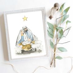 a christmas card with a nativity scene on it next to a plant and star