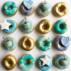 there are many donuts that have been decorated with icing and gold leaf decorations