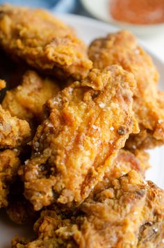 some fried food on a white plate with sauce