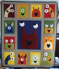 a quilted wall hanging with sesame street characters on it