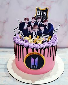 a birthday cake decorated with the bts and music notes on it's icing