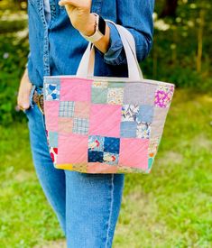 Sweet two-sided tote bag newly handmade from vintage quilt! Gorgeous feedsack fabric and colors. One of a kind and perfect for fall! This adorable bag is made from a stunning vintage (1920/30s) quilt that was past its prime but with lots of love still to give. I chose its very best parts to share, so you can enjoy them too! The bag's two-sided, and both front and back feature an array of alternating solid and four-patch squares. All meticulously hand stitched (both pieced and quilted)! Cheery prints include gingham, flowers and polka dots, and a fabulously fall color palette combines earthy green and brown with pink, gray and blue. The handles are cotton webbing, and the lining's natural canvas. Measuring 14" x 9" x 5", this bag's perfectly sized for brunch and bookstore runs! Thanks to it Quilt Bag, Fall Tote, Feedsack Fabric, Earthy Green, Handmade Purse, Knitting Bag, Feed Sacks, Vintage Quilt, Fall Color Palette