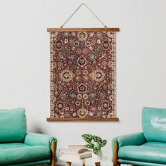 a living room with two couches and a rug hanging on the wall above them