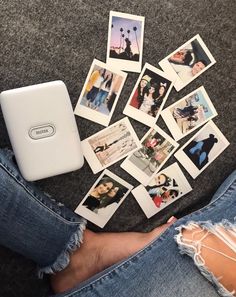 a person sitting on the floor with their legs crossed and several polaroid pictures scattered around them