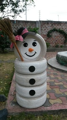 there is a snowman made out of toilet paper and a broom in the yard