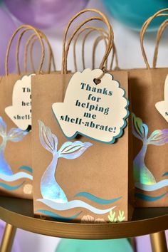 three brown bags with blue and white designs on them