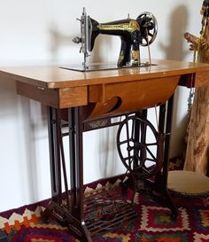 an old sewing machine sitting on top of a wooden table